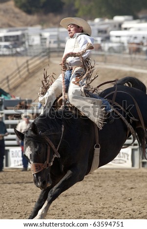 stock-photo-san-dimas-ca-october-unidentified-cowboy-competes-in-the-saddle-bronc-event-at-the-san-dimas-63594751.jpg